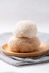 Lion's Mane mushroom or Yamabushitake mushroom on wooden plate
