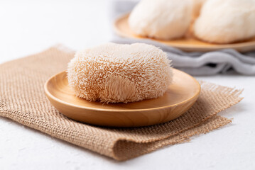 Lion's Mane mushroom or Yamabushitake mushroom on wooden plate