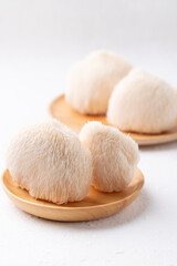 Lion's Mane mushroom or Yamabushitake mushroom on wooden plate