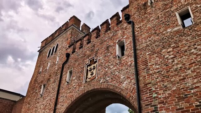 Historic Landtor brick gate and tower with cloudy sky in Landshut, Germany