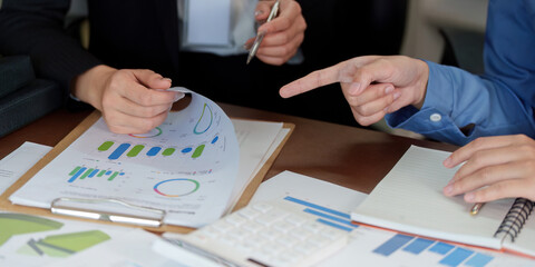 Business Collaboration. Professionals analyzing data and discussing strategies in a corporate setting.