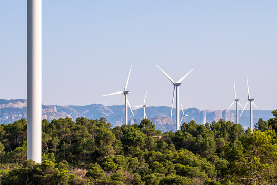 Wind turbines on green hills of Terra Alta near Horta de San Juan Tarragona Catalonia Spain renewable energy landscape under Mediterranean sunlight symbol of sustainability and progress