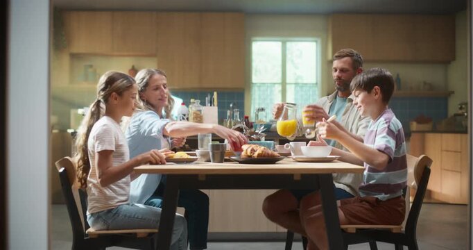 Parents and Children Gather in a Bright Kitchen, Enjoying Breakfast While Discussing School and Cooking Tips. Happy Energetic Parents and Children Have Healthy Meal and Daily Routine
