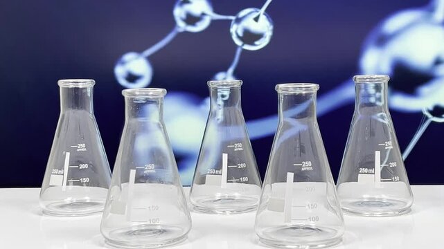 Set of empty laboratory Erlenmeyer flasks on white surface with scientific molecular structure background, scientific glassware concept for chemistry and research