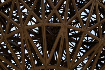 Detailed close-up of an intricate geometric structure made of metal beams. Perfect for architecture, interior design, metal constructions, engineering, decorative elements, and visual projects	