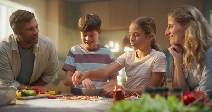 Family Makes A Homemade Pizza Together In A Sunlit Kitchen, Using Fresh Vegetables And Ingredients. Parents And Children Cook Side By Side, Sharing Joy While Preparing Healthy Homemade Food 