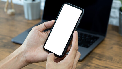 Hands of a businessman using a  smartphone mockup at his desk, Mobile phone blank screen for editing graphics.