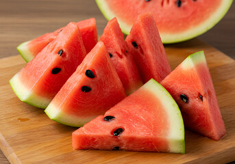 Fresh red watermelon slices on rustic wooden cutting board with juicy texture