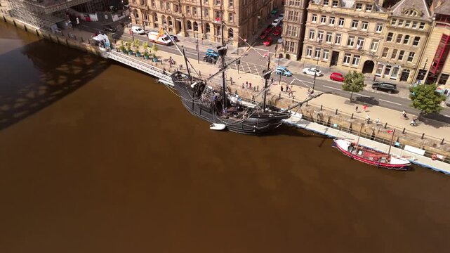 Newcastle upon Tyne: 24th July 2025: Nao Victoria ship docked at Tyne Quayside with city backdrop and visitors exploring the historic vessel. Drone footage