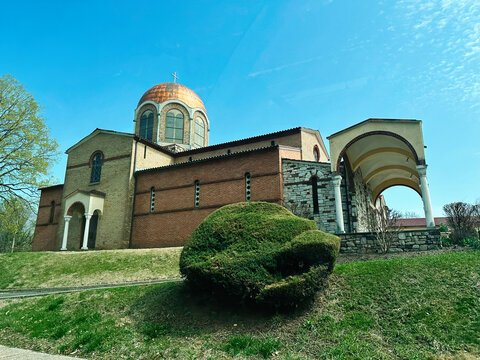 Historic Annunciation Greek Orthodox Church with copper dome under blue sky in Elkins Park, PA