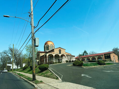 Ornate Annunciation Greek Orthodox Church with golden dome surrounded by greenery in Elkins Park, PA