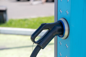 Electric Vehicle Charging Station With a Plug Connected Ready for Use in a Modern Urban Setting