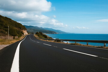 Scenic coastal road with clear blue sky and ocean view