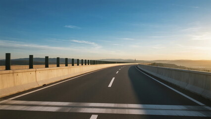 Fototapeta premium Smooth asphalt road under clear blue sky with barriers