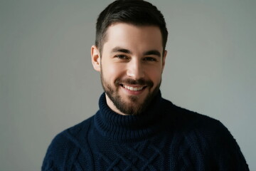 Obraz premium A man wearing a dark blue turtleneck sweater with a smiling expression