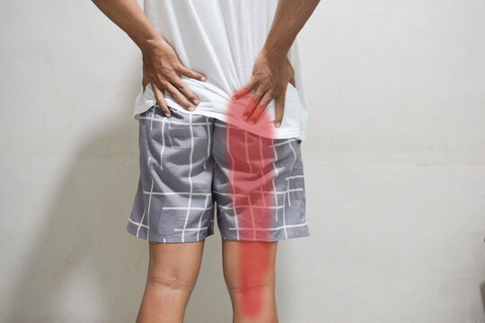 sciatica pain concept with young man from button pain spreading to down leg