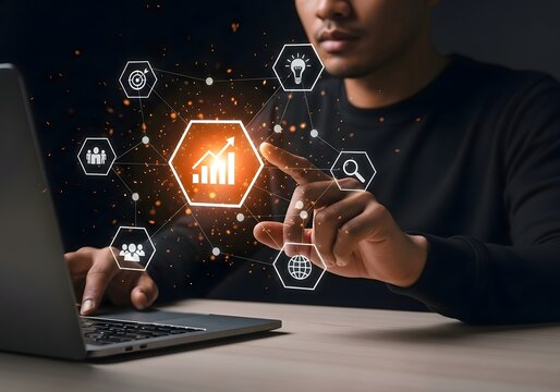 Person interacting with digital interface on laptop showing business growth icons around them - Powered by Adobe