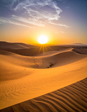 The sun setting over the Grand Bara Desert, with wind-swept sand dunes in the foreground.