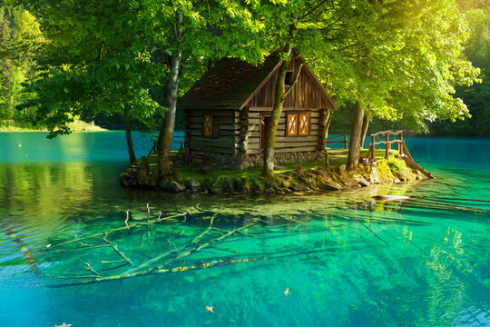 Enchanting wooden cabin nestled on a tiny island in a vibrant turquoise lake