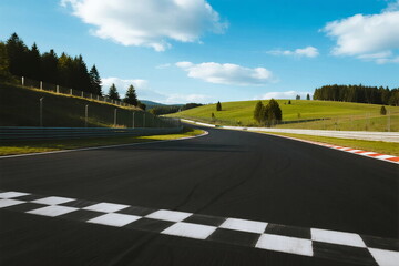 A winding race track with checkered start line in a scenic landscape