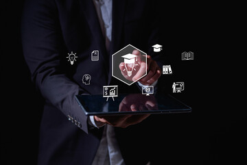 Businessman using digital tablet with virtual education and business icons, representing online learning, innovation, e-learning, professional training knowledge development