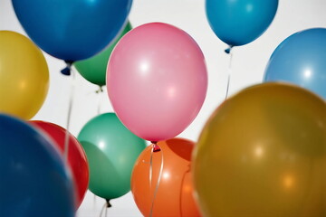Colorful balloons floating in the air showing various bright hues
