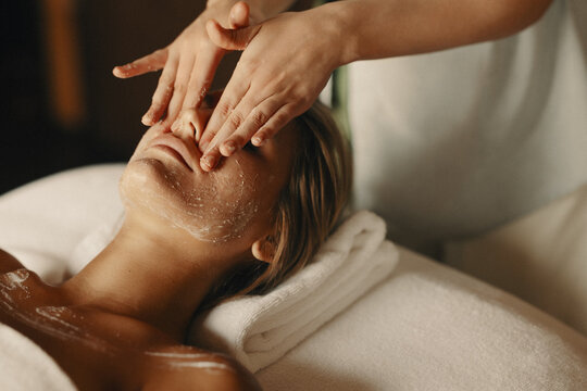 Woman enjoying a relaxing facial treatment at a spa