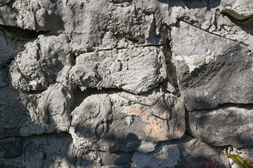 Texture of weathered stone wall with natural patterns