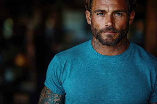 Focused Crossfit Trainer In Bright Blue Shirt With Inked Arms