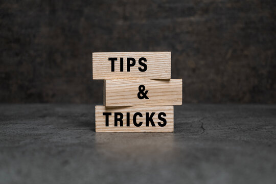 tips and tricks words on wooden blocks isolated on dark background