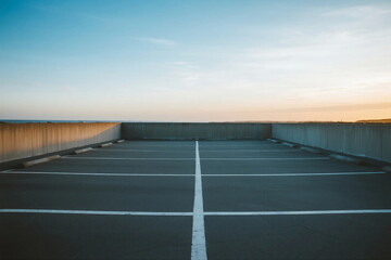 Empty parking lot under clear sky during sunset time