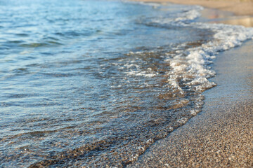 Beautiful wavy sea and sandy beach, closeup