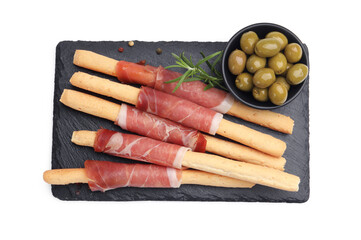 Delicious grissini sticks with prosciutto, green olives and rosemary isolated on white, top view