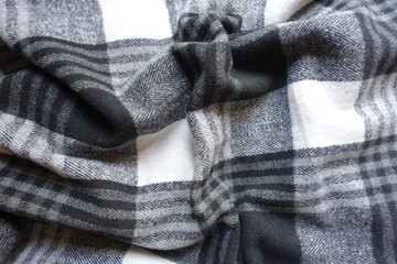Soft folds on black and white checkered cotton flannel fabric