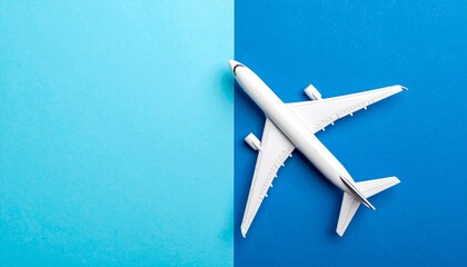 A white airplane positioned diagonally on a split blue background, symbolizing travel and flight