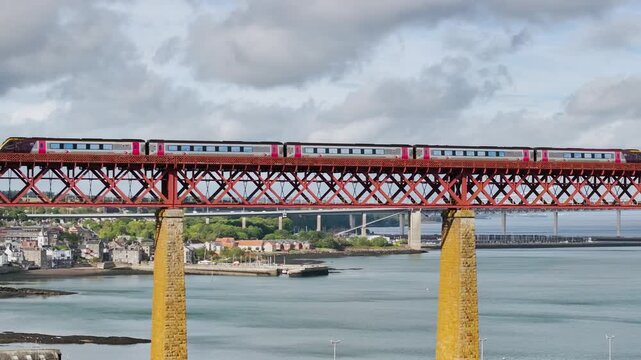 Trains on Forth Bridge from a drone, Queensferry Crossing, Forth Estuary, Scotland