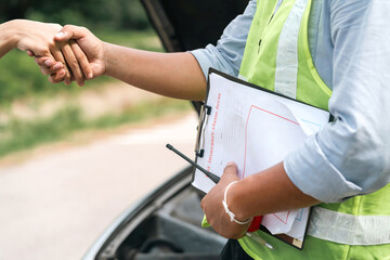insurance impressed woman service shake hand. insurance handling problem so good make asian driver happy showing respect. company expertise checking motor or car after accident make woman shake hand