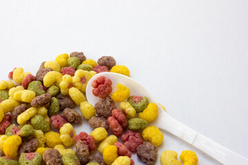 Colorful fruit flavored cereal isolated on white background.