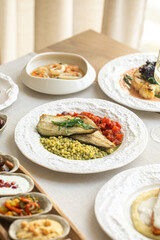 Assorted gourmet dishes with vegetables seafood and wine on elegant table