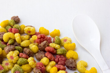 Colorful fruit flavored cereal isolated on white background.
