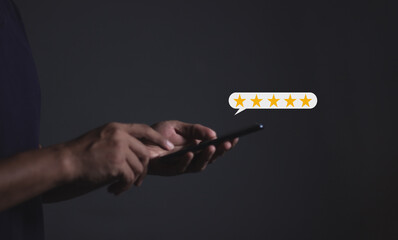 Review Customer, Young Man hand holding Smart Phone with five star to review and give 5 stars with very good results in service, Good review 5 star rating choice feedback