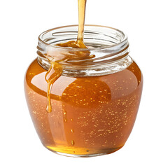 Golden honey pouring into a glass jar with a black background