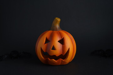 Carved pumpkin jack-o-lantern with menacing face on dark background, Halloween decoration symbolizing spooky tradition and seasonal festivity
