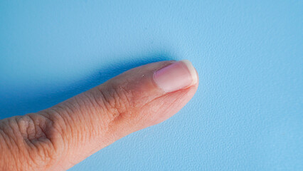 one separated pinky little finger floating with light blue background