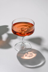 Drink in a glass, plant shadows