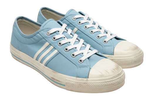 Isolated pair of light blue casual sneakers, canvas shoes with white laces and stripes