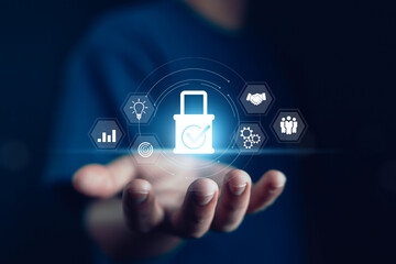 Businessman hand holding digital padlock with business icons, concept of cybersecurity, data protection, secure business process, privacy, innovation, teamwork, and digital transformation technology.