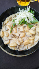 Creamy gnocchi dish with mushrooms and cheese topped with fresh herbs. in Ljubljana, Slovenia