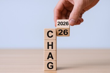 Strategic Year Transition: Hand Places Wooden Block to Symbolize Growth, Progress, and a Vision for the Future