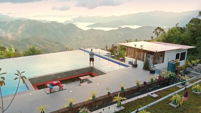 Luxury mountain resort infinity pool with panoramic view of misty hills at sunrise. Perfect for travel, tourism, wellness, real estate, and cinematic lifestyle projects.